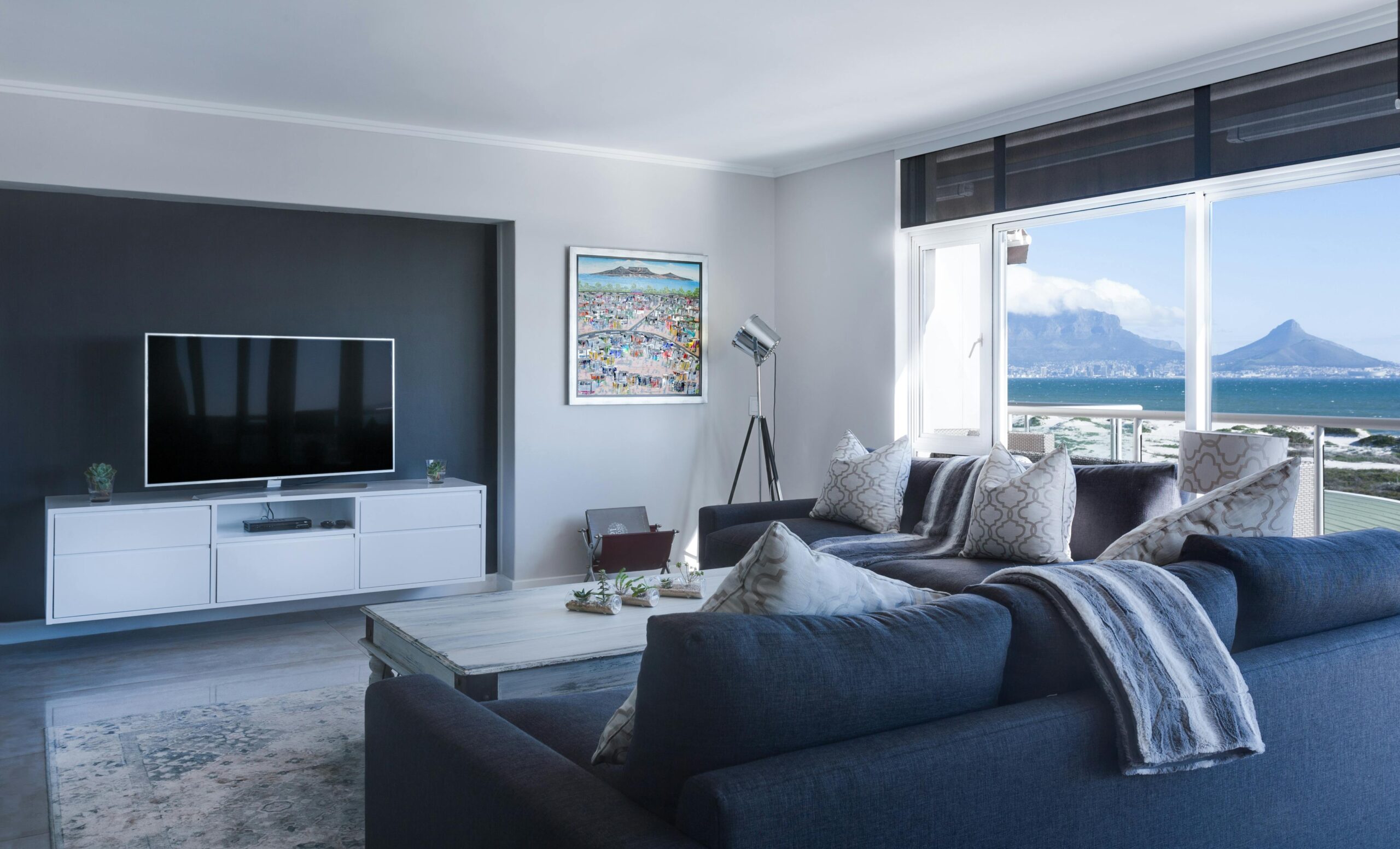 pexels-photo-1457842-1457842 Stylish living room with a view of Table Mountain, blending modern design with natural beauty.